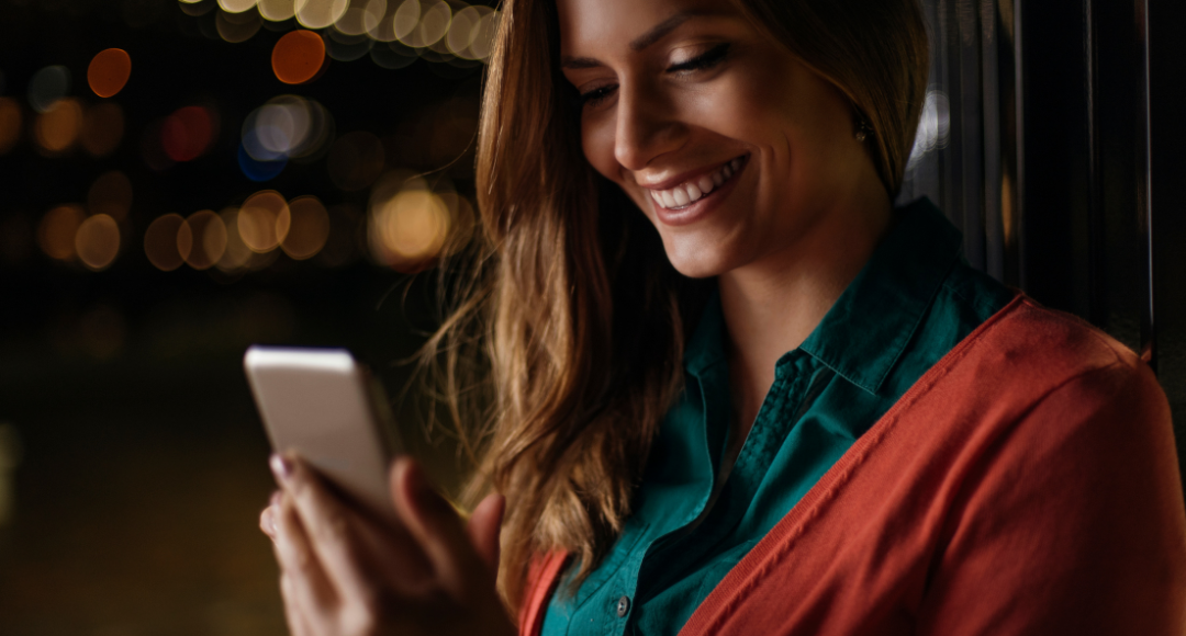 Kvinde i grøn og rød har lige fået flere data til sit mobilabonneemt hos velkommen .png